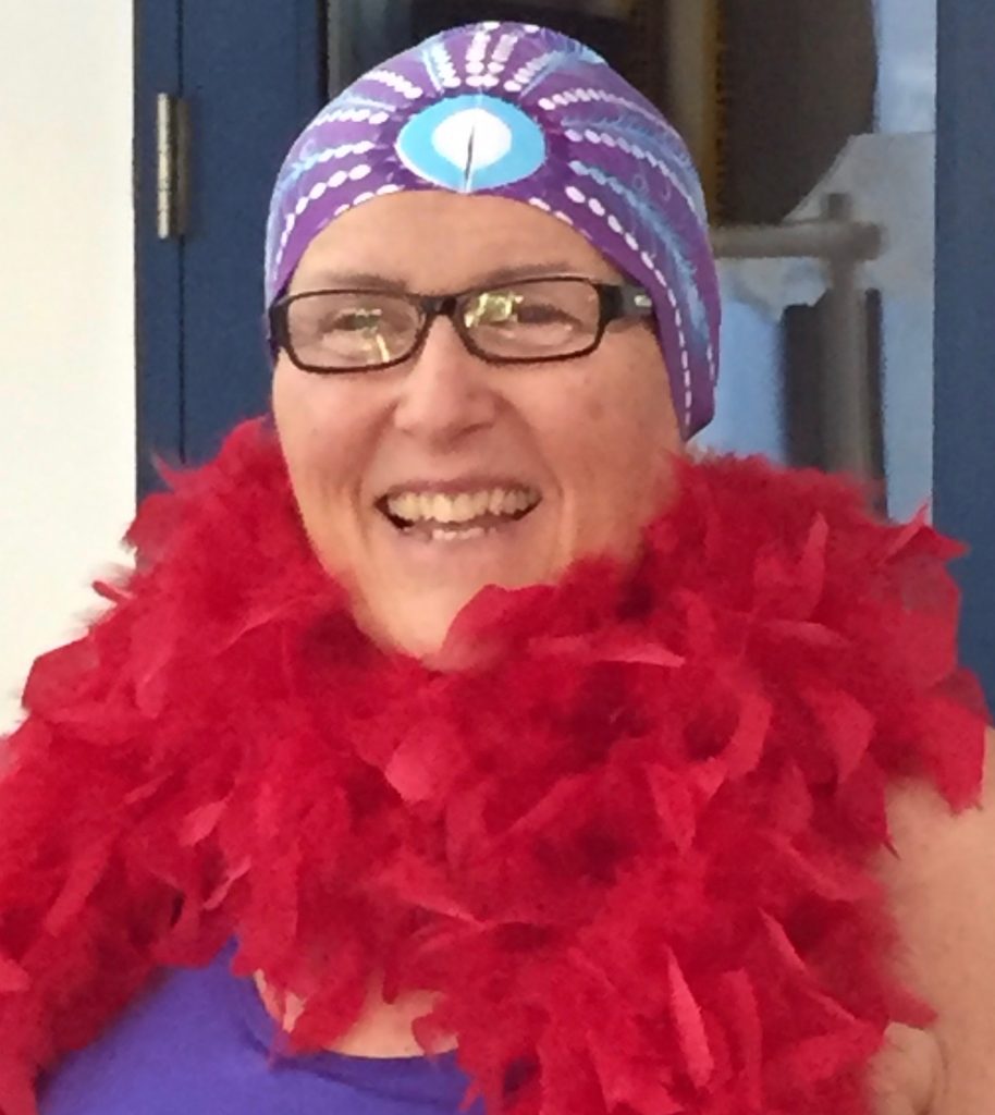 woman in red feathers and swim cap