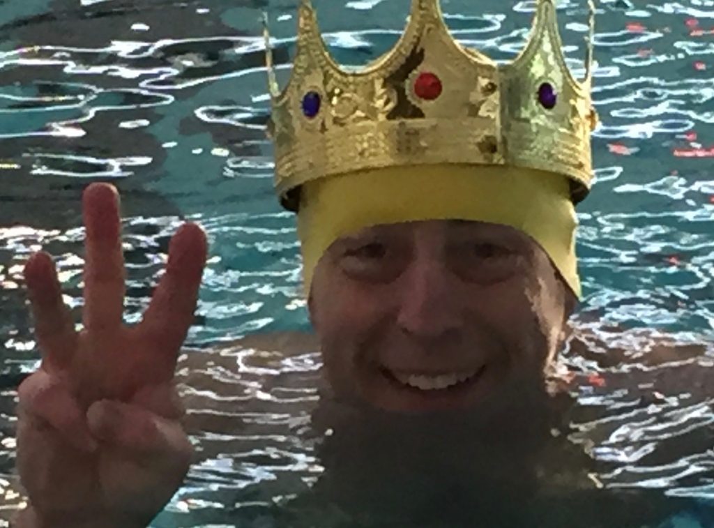 man in pool wearing crown